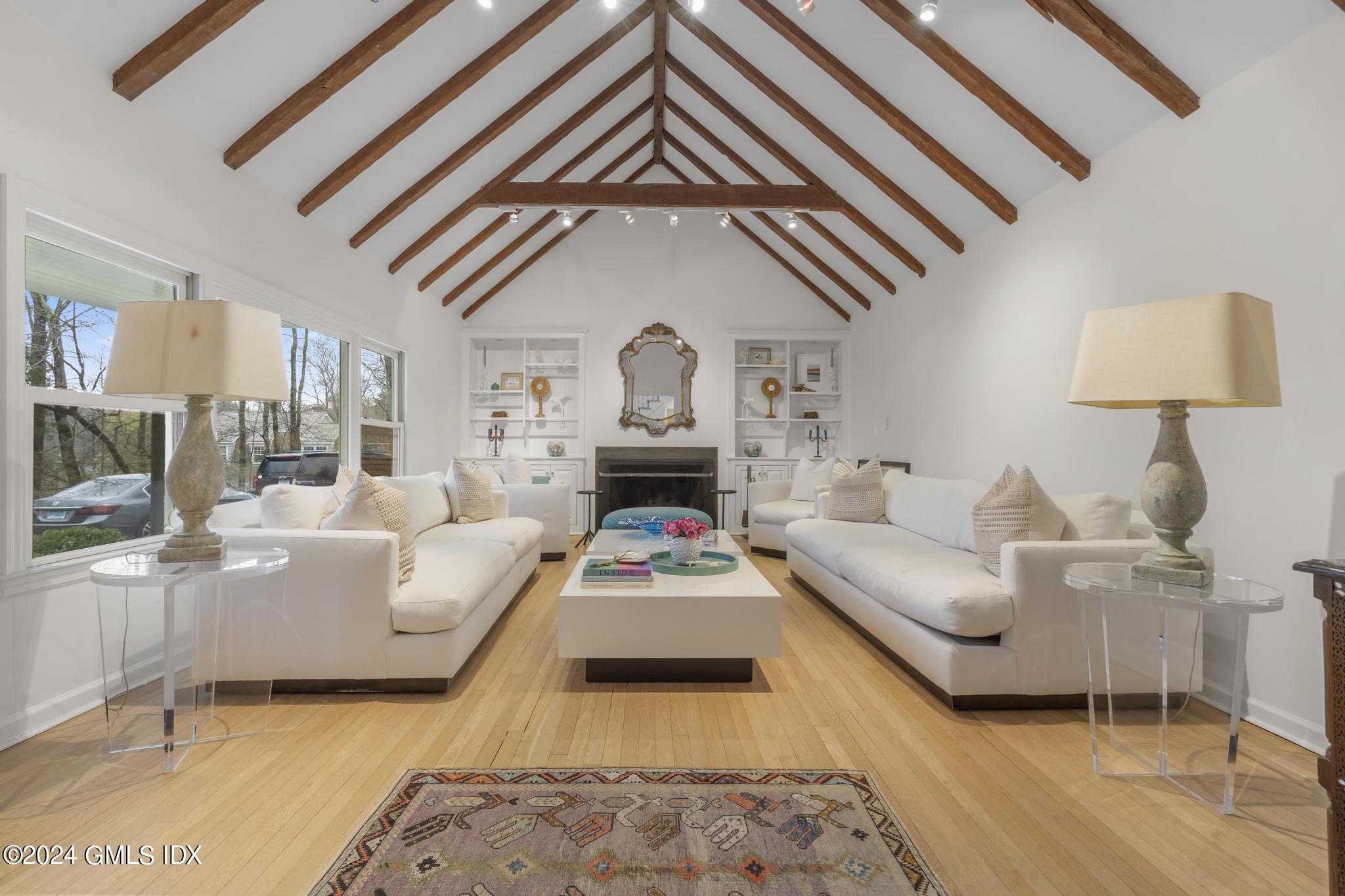 311 Cognewaugh Road Cos Cob, CT 06807 - Photo 3 of 28 a living room with furniture and a fireplace