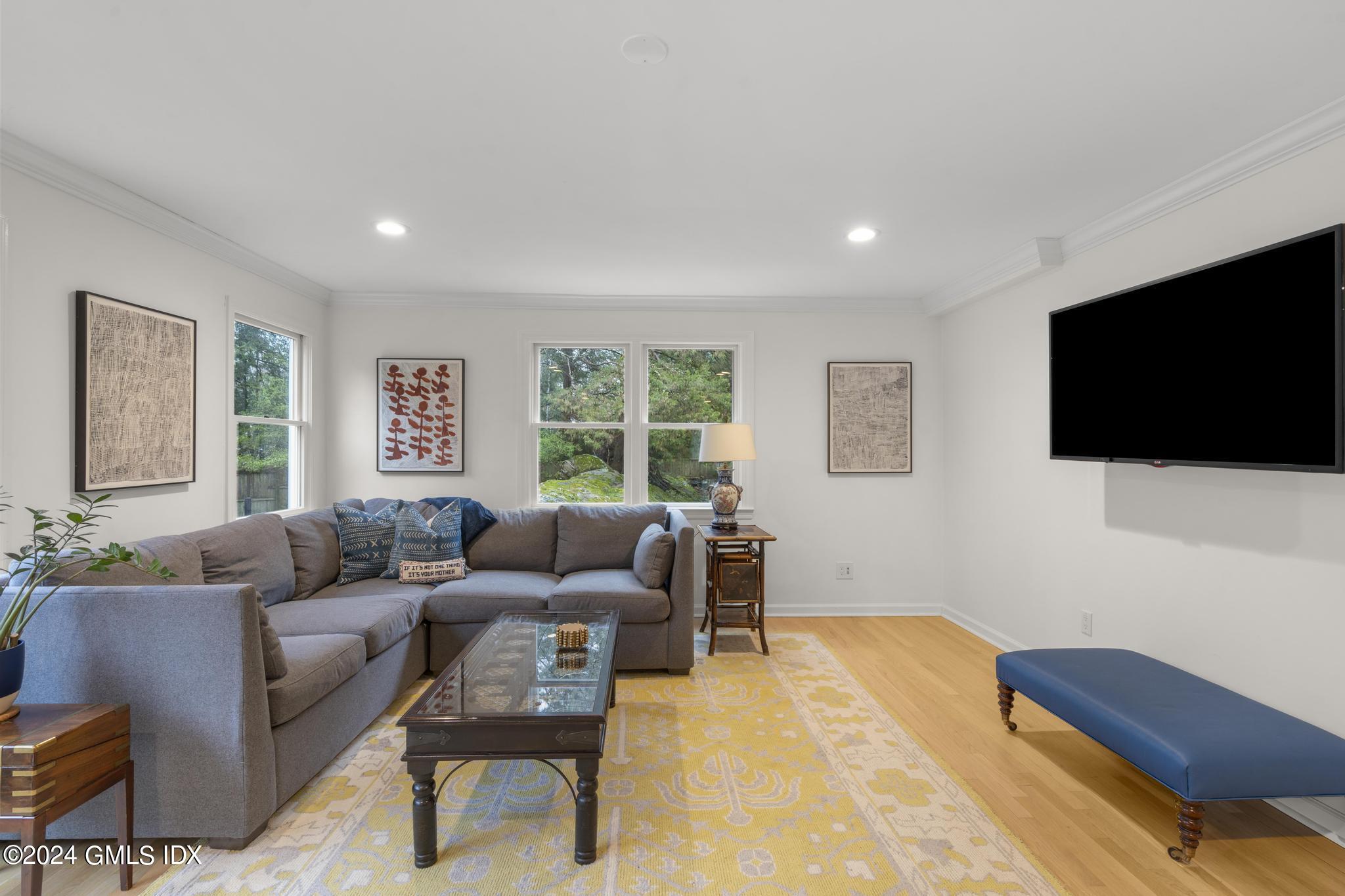 311 Cognewaugh Road Cos Cob, CT 06807 - Photo 8 of 28 a living room with furniture and a flat screen tv