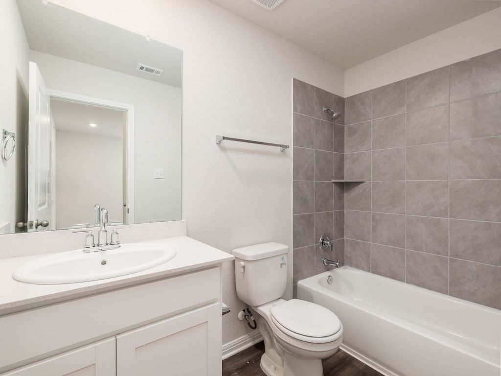 105 Texas Agate Drive, Unit 5 Kyle, TX 78640 - Photo 10 of 19 a bathroom with a sink toilet and shower