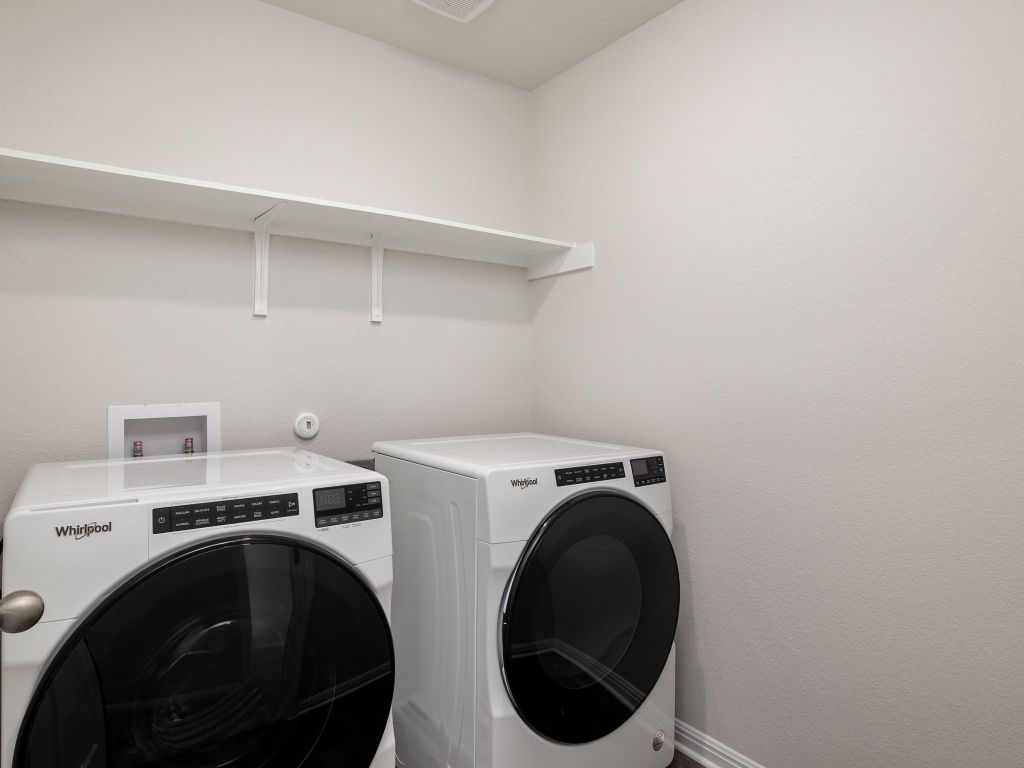 105 Texas Agate Drive, Unit 5 Kyle, TX 78640 - Photo 11 of 19 a utility room with dryer and washer