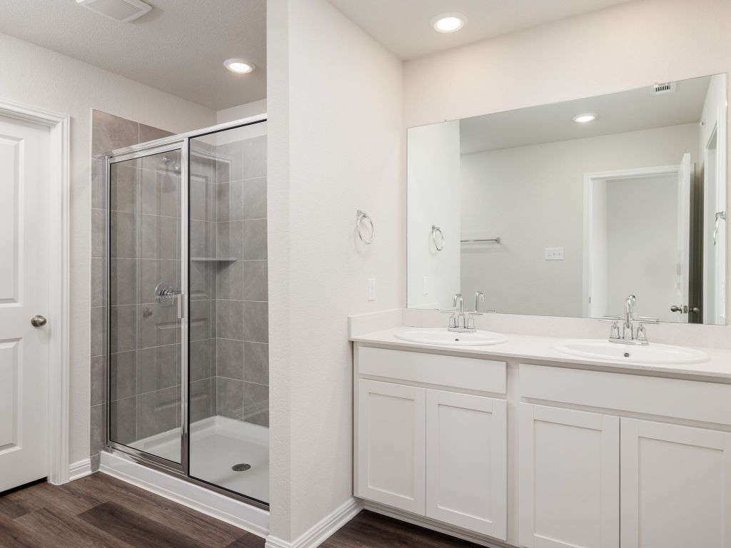 105 Texas Agate Drive, Unit 5 Kyle, TX 78640 - Photo 14 of 19 a bathroom with a shower sink and mirror
