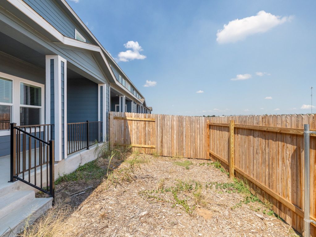 105 Texas Agate Drive, Unit 5 Kyle, TX 78640 - Photo 16 of 19 a view of a house with wooden floor in front of house
