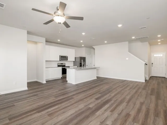 a view of kitchen with granite countertop cabinets and wooden floor