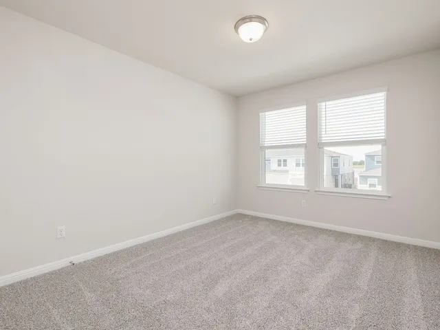 a view of kitchen with granite countertop wooden floor stainless steel appliances and a window