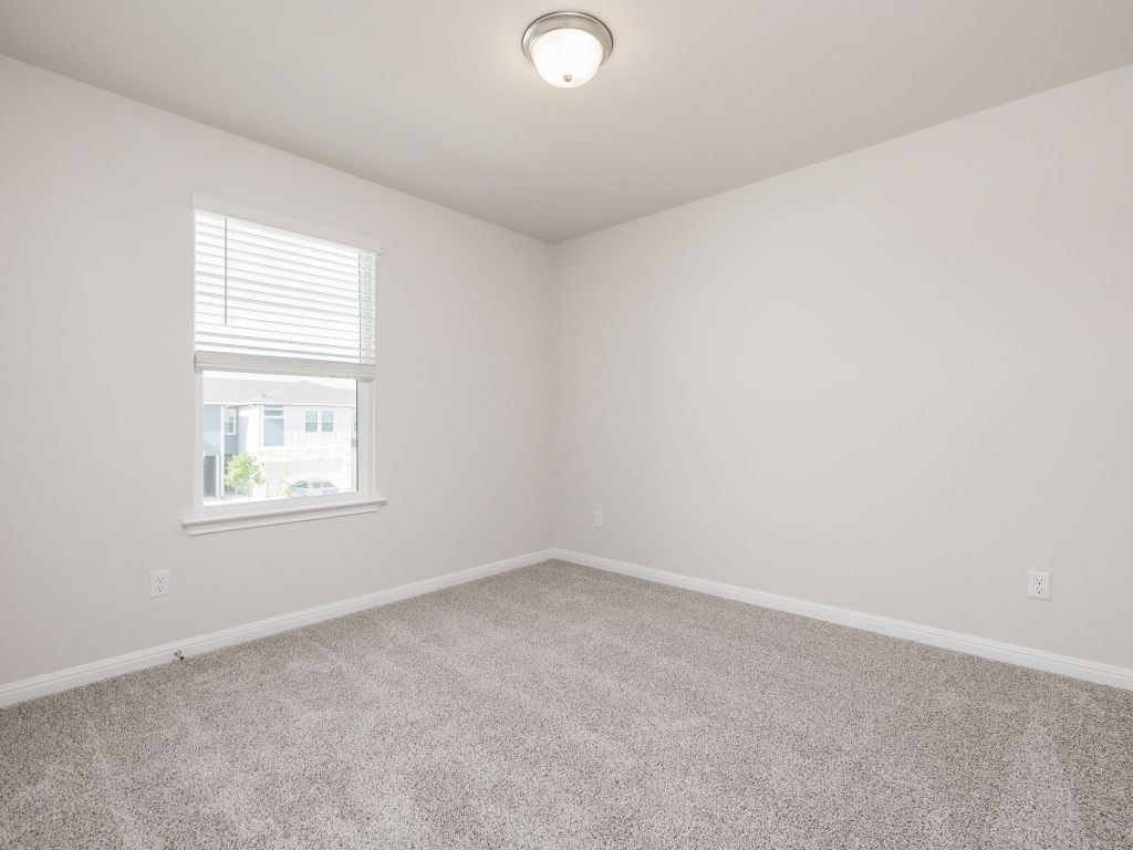 105 Texas Agate Drive, Unit 5 Kyle, TX 78640 - Photo 9 of 19 an empty room with a window