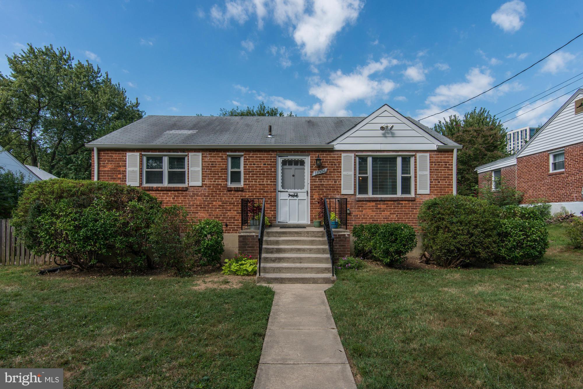 11004 Bucknell Drive Silver Spring, MD 20902 - Photo 1 of 30 a front view of a house with a garden