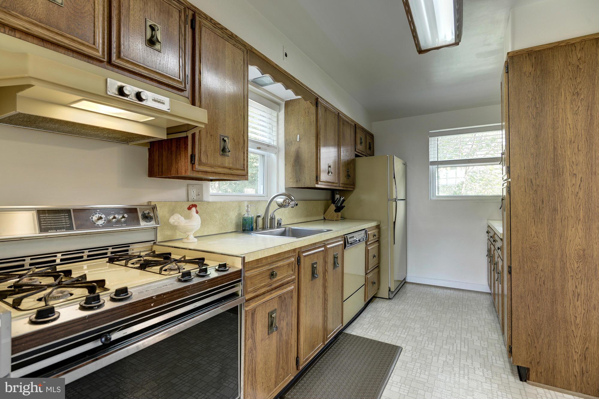11004 Bucknell Drive Silver Spring, MD 20902 - Photo 11 of 30 a kitchen with stainless steel appliances a stove a sink and cabinets