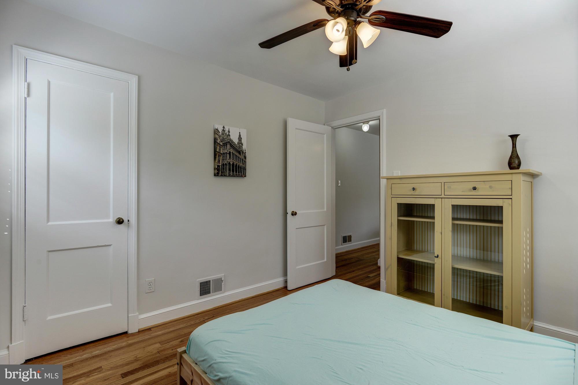 11004 Bucknell Drive Silver Spring, MD 20902 - Photo 22 of 30 a bedroom with a bed and a ceiling fan