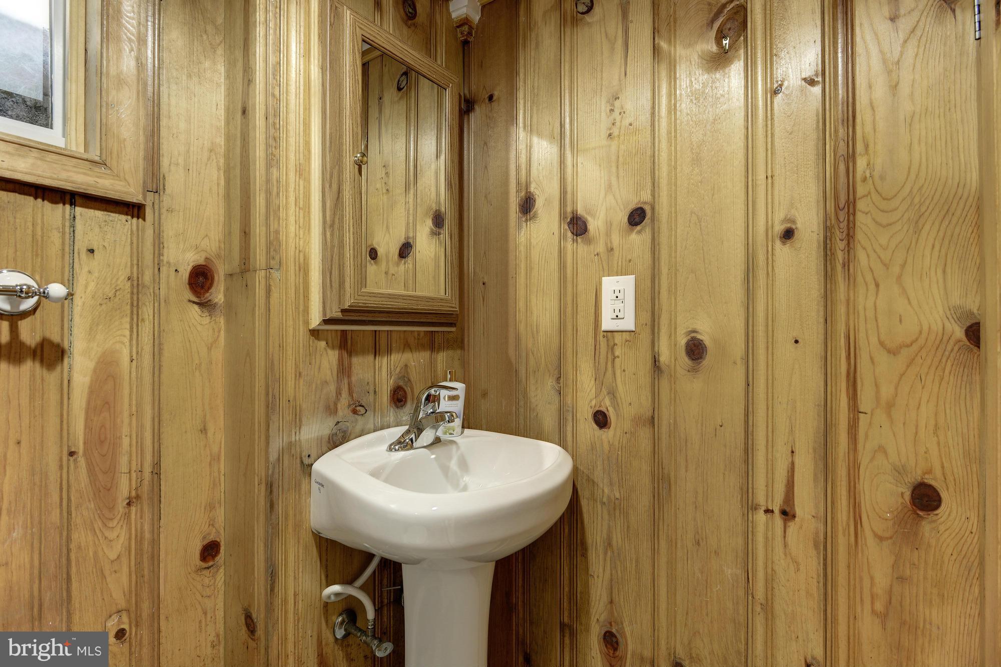 11004 Bucknell Drive Silver Spring, MD 20902 - Photo 27 of 30 a bathroom with a sink a mirror a vanity and shower