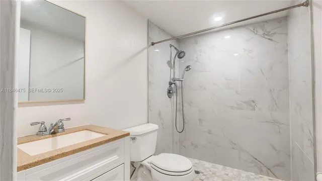 a bathroom with a toilet sink and shower
