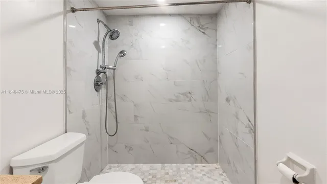 a bathroom with a toilet sink and shower