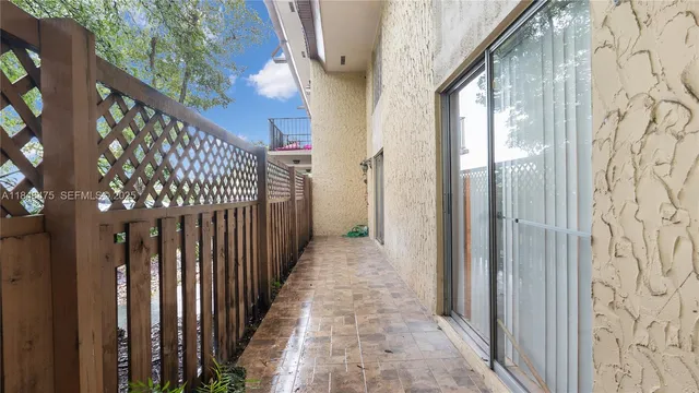 an aerial view of a house with garden space and street view