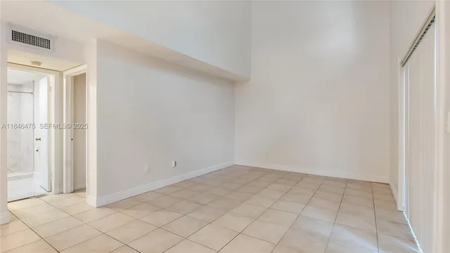 a kitchen with granite countertop a sink stainless steel appliances and white cabinets