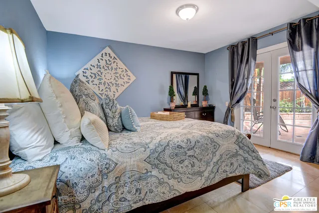 a view of a patio with table and chairs and potted plants