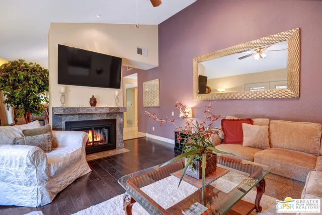 a living room with furniture fireplace and flat screen tv
