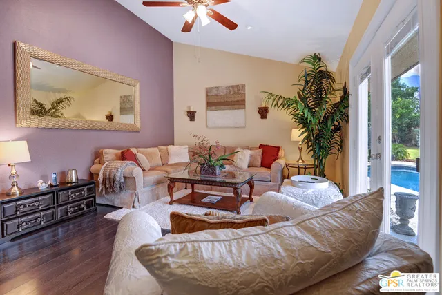 a living room with furniture and a potted plant