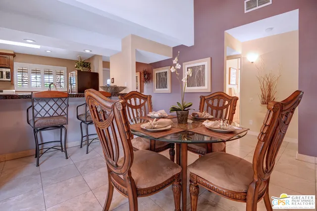 a view of a dining room and livingroom with furniture and window