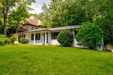 a front view of house with a garden and porch
