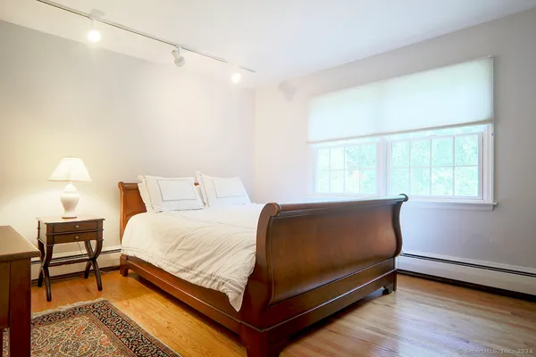 a bedroom with a bed and a window