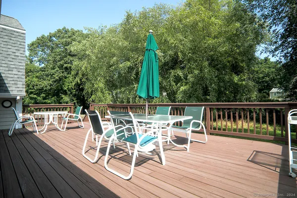 a view of a chairs and table on the wooden deck