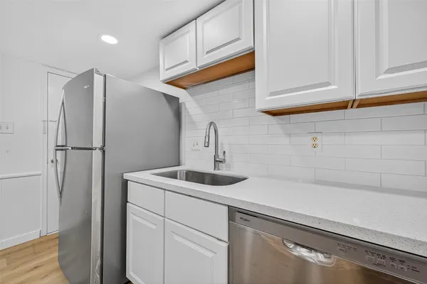 a kitchen with a sink and refrigerator