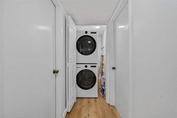 a view of a hallway with washer and dryer