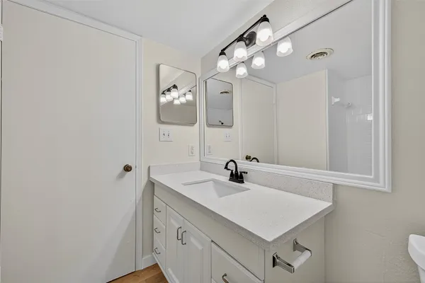 a bathroom with a sink vanity and mirror
