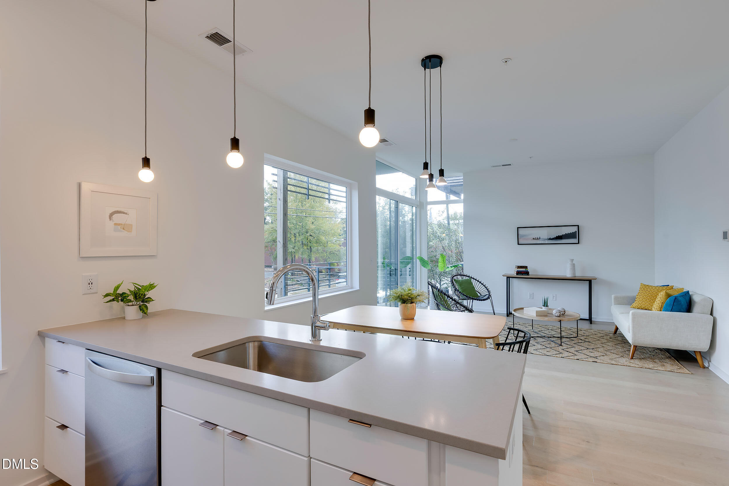521 North Mangum Street, Unit 21 Durham, NC 27701 - Photo 10 of 21 a view of a kitchen with kitchen island a counter top a sink and cabinets
