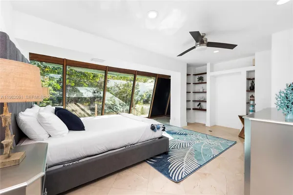 a bedroom with a large bed and a large window