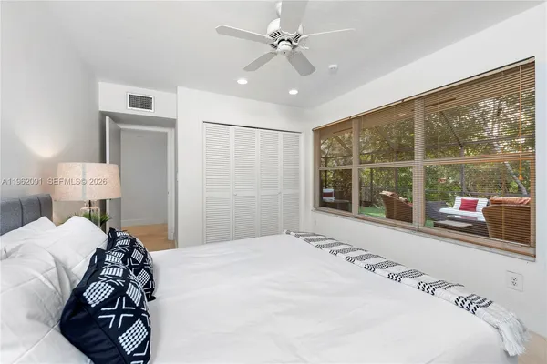 a bedroom with a large bed and a window