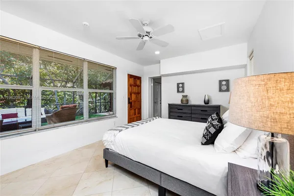 a bedroom with a large bed and a large window