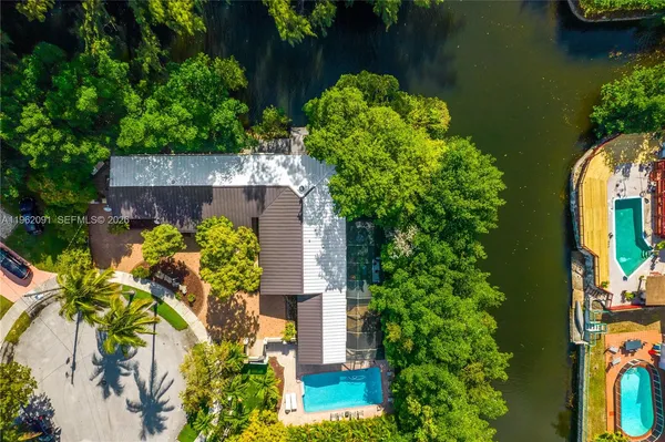 an aerial view of a house with a yard and garden