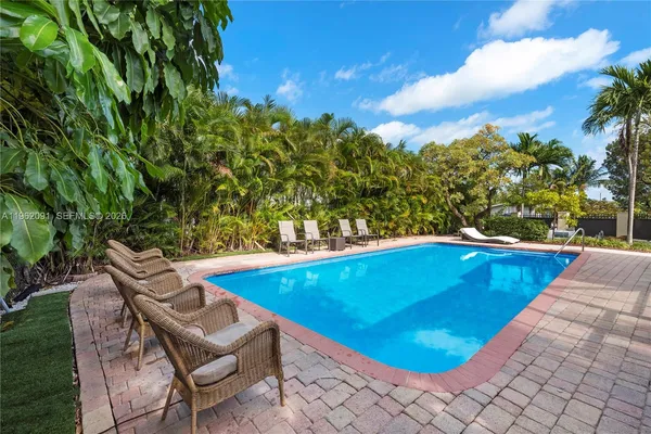 a view of a swimming pool with an outdoor seating