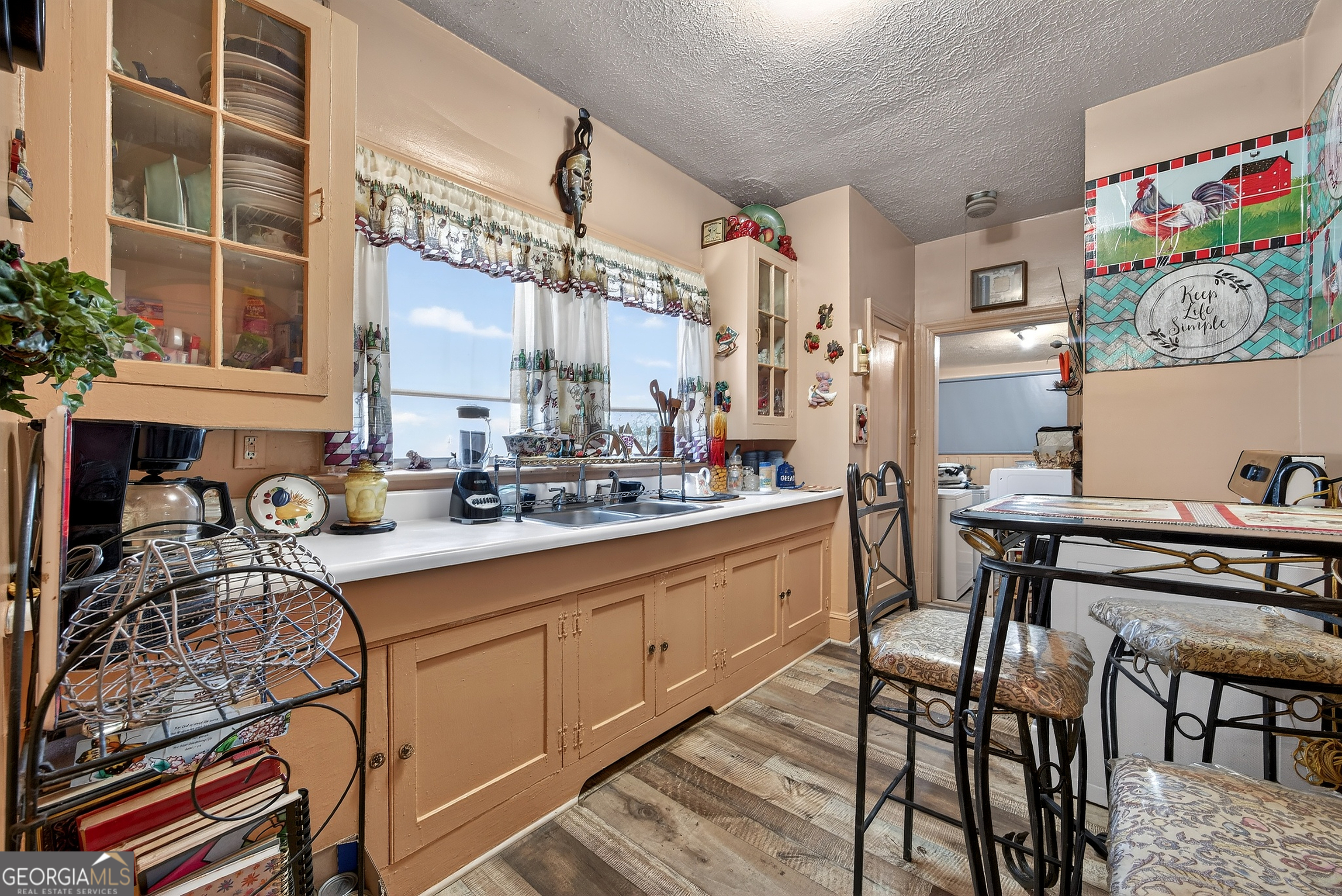 1695 Beecher Street Southwest Atlanta, GA 30310 - Photo 15 of 23 a kitchen with stainless steel appliances granite countertop a table and chairs in it