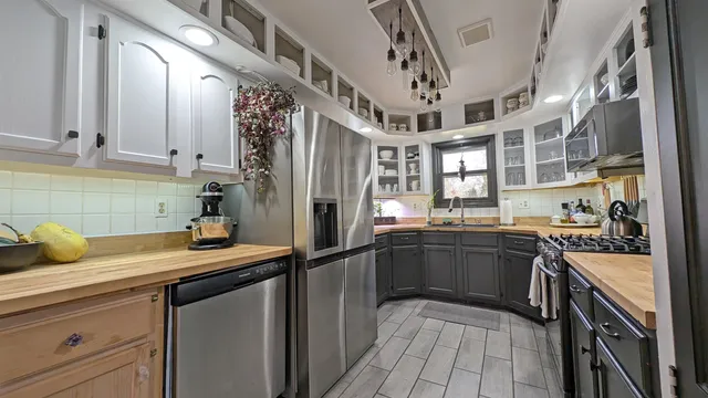 a kitchen with a sink appliances and cabinets