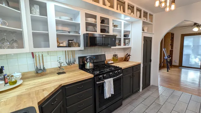 a kitchen with stainless steel appliances granite countertop a stove and a sink