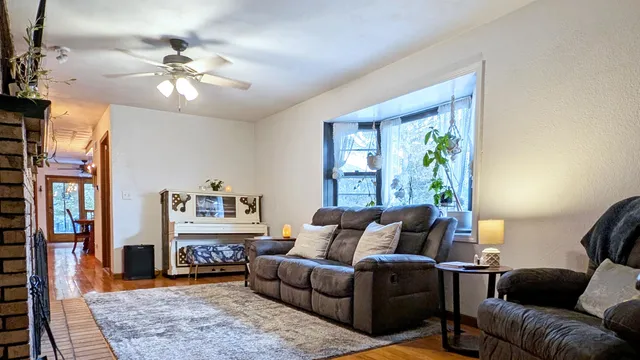 a living room with furniture and a chandelier
