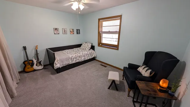 a bedroom with bed and a window