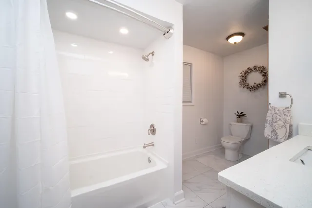 a bathroom with a bathtub sink and toilet