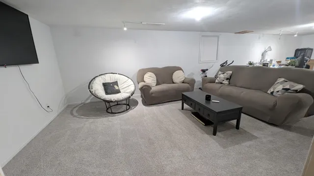 a living room with furniture and a lamp