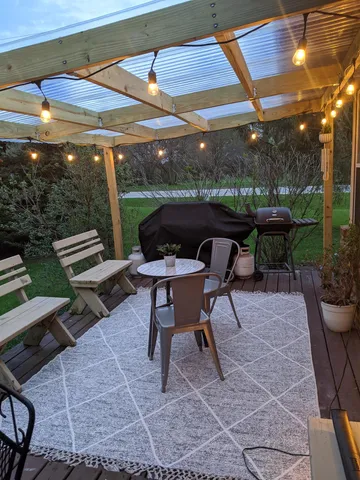 a view of a patio with a table and chairs