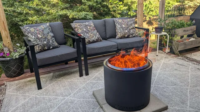 a view of outdoor sitting area with furniture and fire pit