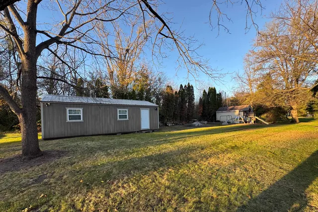 a view of a backyard with large trees