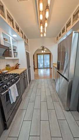 a view of a kitchen with a stove and cabinets