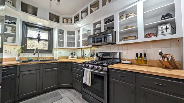 a kitchen with stainless steel appliances granite countertop a sink and cabinets