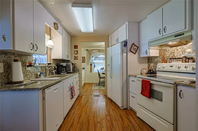 a kitchen with stainless steel appliances a refrigerator sink and cabinets