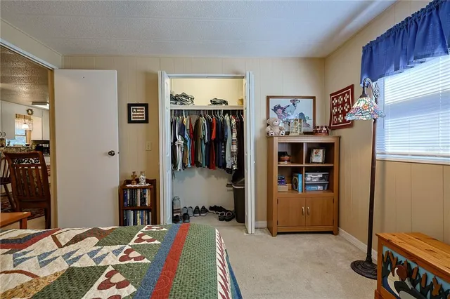 a bedroom with a bed and a table chair