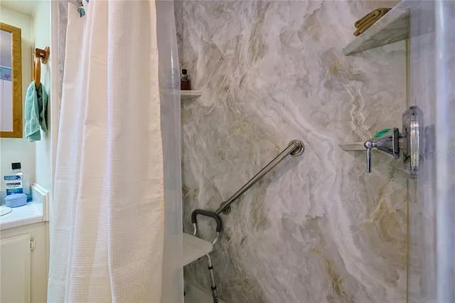 a spacious bathroom with a double vanity sink a mirror and shower