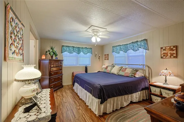 a bedroom with a bed and a mirror on the dresser
