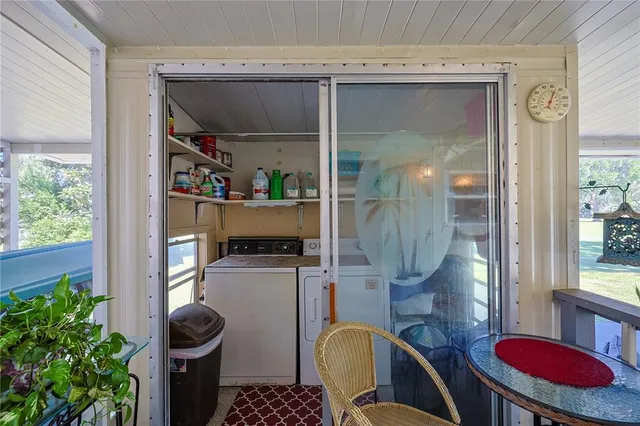 a view of a porch with furniture and a yard